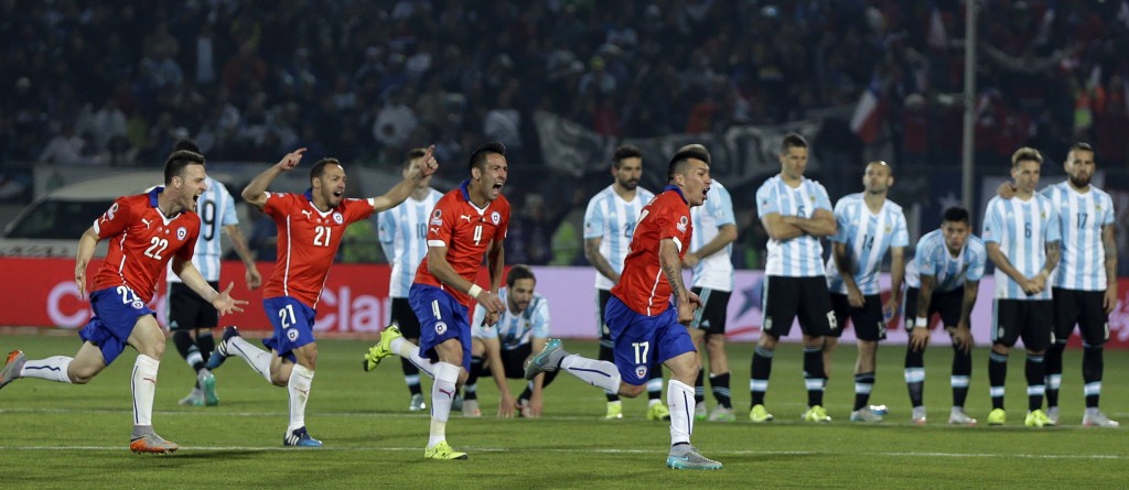 Chile's players run in celebration during penalty shootout at the Copa America final soccer match against Argentina at the National Stadium in Santiago, Chile, Saturday, July 4, 2015. Chile won the Copa America on penalty shootout.(AP Photo/Natacha Pisarenko)