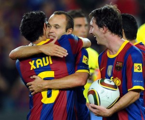 Barcelona's midfielder Andres Iniesta (C), Barcelona's midfielder Xavi Hernandez (L) and Barcelona's Argentinian forward Lionel Messi (R) celebrate after winning the Supercup trophy after a second leg football match against Sevilla on August 21, 2010 at Camp Nou stadium in Barcelona. AFP PHOTO/LLUIS GENE (Photo credit should read LLUIS GENE/AFP/Getty Images)